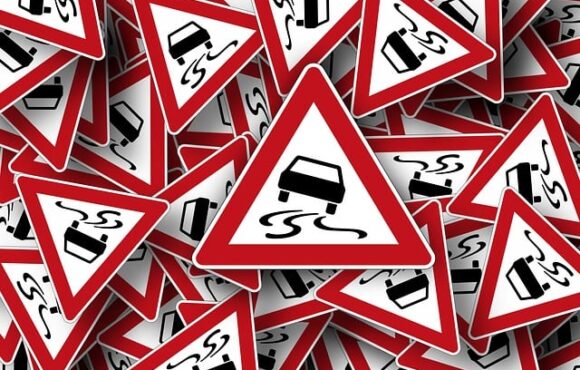 What Info would be shown in a Triangular Road Sign?